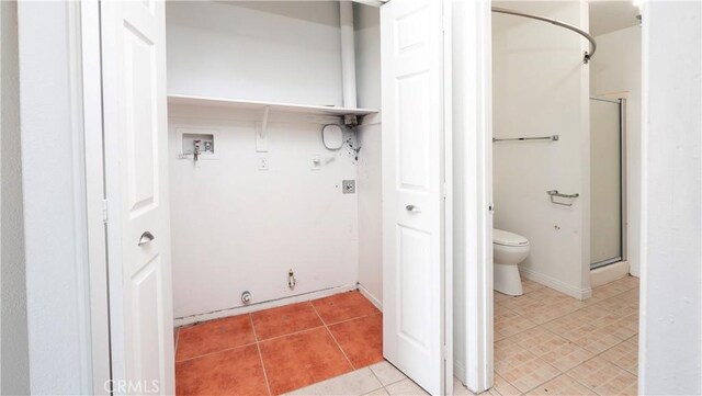 bathroom featuring a shower with shower door, tile patterned floors, and toilet