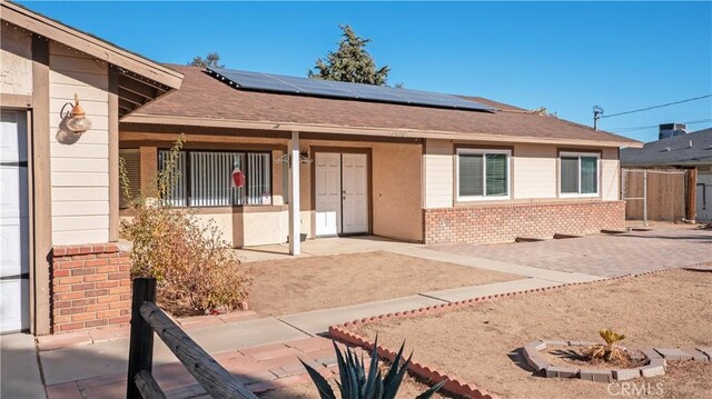 doorway to property featuring solar panels