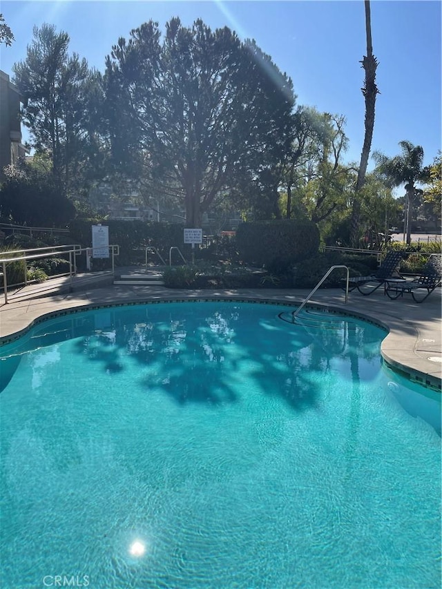 view of swimming pool with a patio