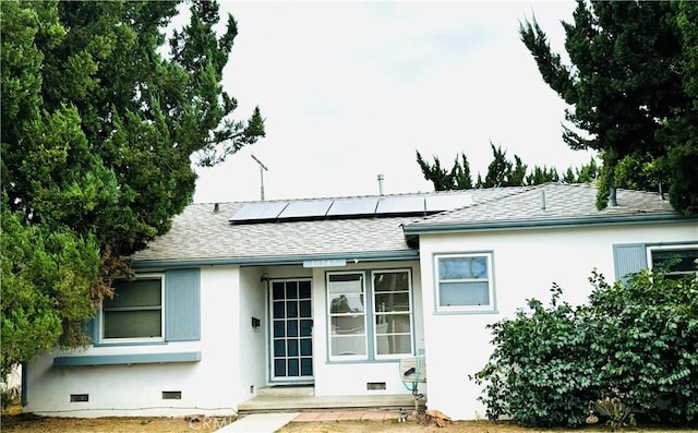 back of house with solar panels