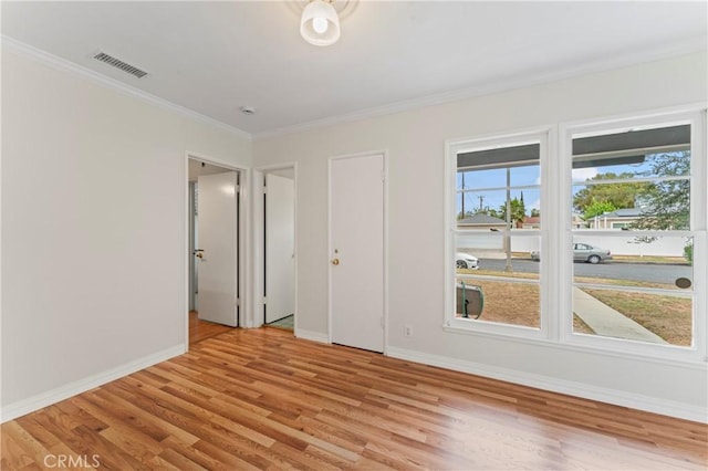 spare room with light hardwood / wood-style floors and ornamental molding