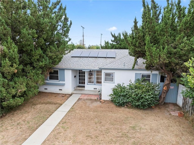 ranch-style house with solar panels