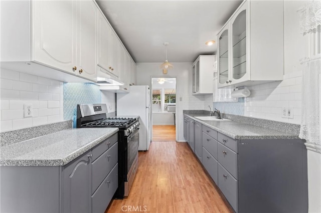 kitchen with white cabinets, gray cabinets, light hardwood / wood-style flooring, and stainless steel range with gas cooktop