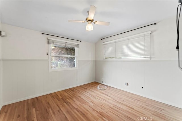 unfurnished room with vaulted ceiling, light hardwood / wood-style flooring, and ceiling fan