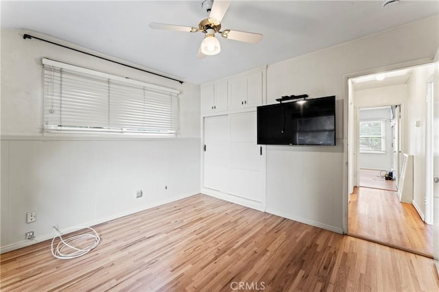 interior space featuring ceiling fan, a closet, and light wood-type flooring