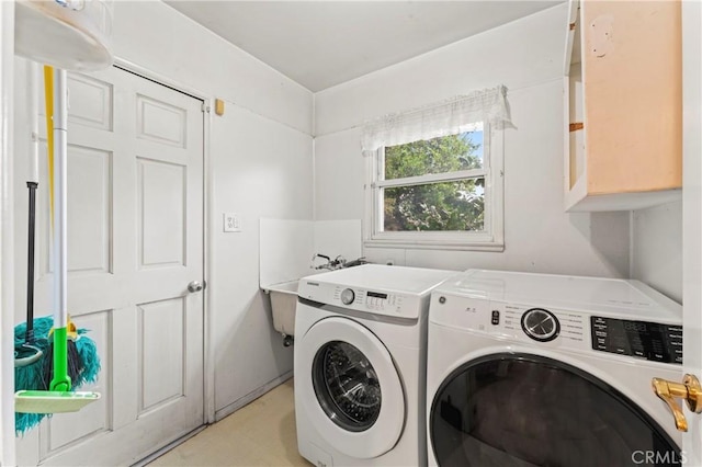 laundry area featuring cabinets and washer and clothes dryer