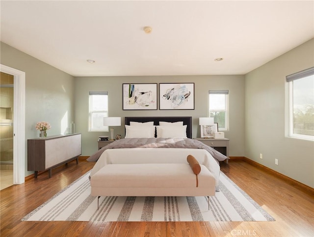 bedroom featuring hardwood / wood-style floors and multiple windows