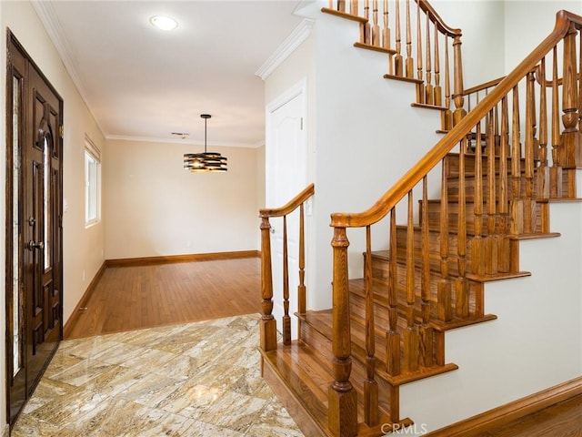 entryway featuring hardwood / wood-style floors and ornamental molding