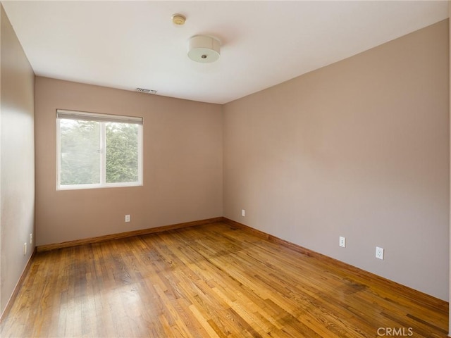 spare room featuring light hardwood / wood-style floors