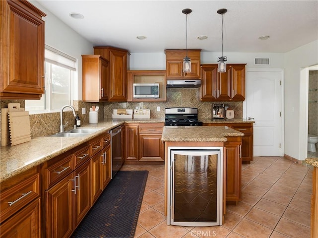 kitchen with sink, appliances with stainless steel finishes, wine cooler, decorative backsplash, and decorative light fixtures