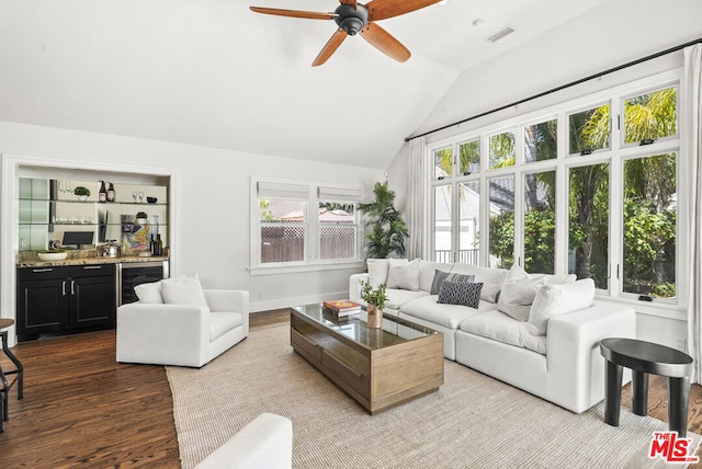 living room with light wood-type flooring, vaulted ceiling, ceiling fan, and beverage cooler