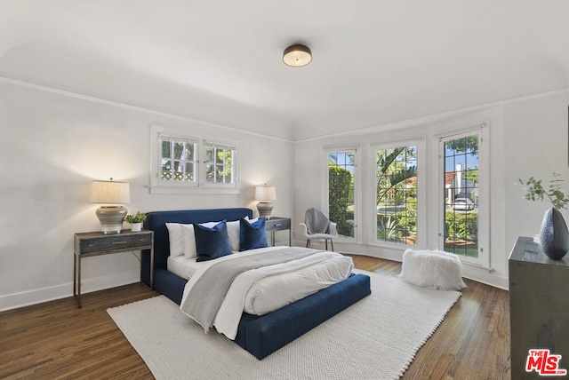 bedroom featuring dark hardwood / wood-style floors and ornamental molding