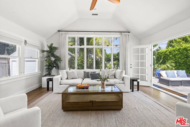 sunroom with lofted ceiling, ceiling fan, and a healthy amount of sunlight