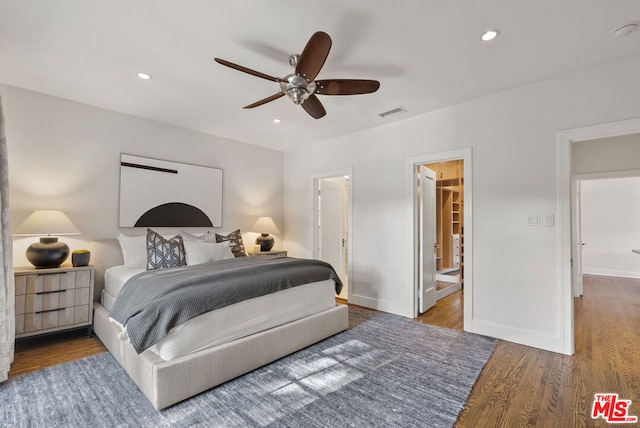 bedroom with ceiling fan, wood-type flooring, and ensuite bath