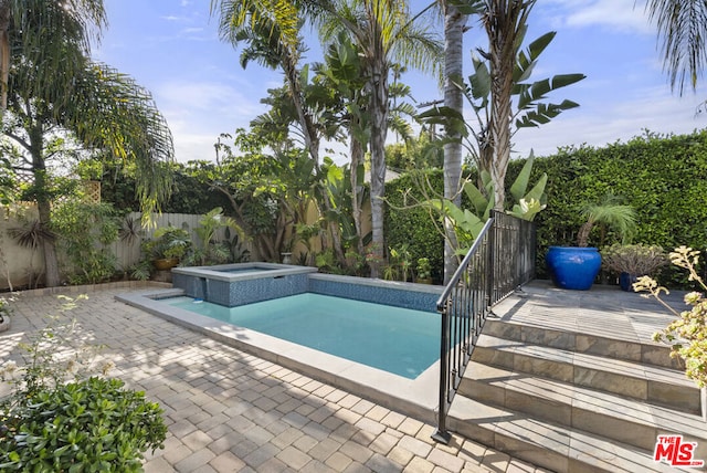 view of pool with an in ground hot tub and a patio