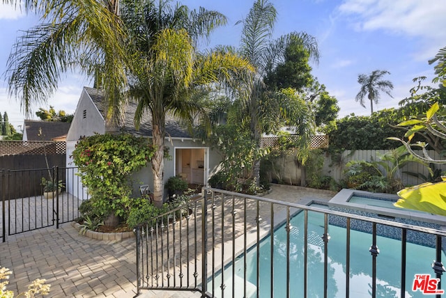 view of pool featuring an in ground hot tub and a patio area