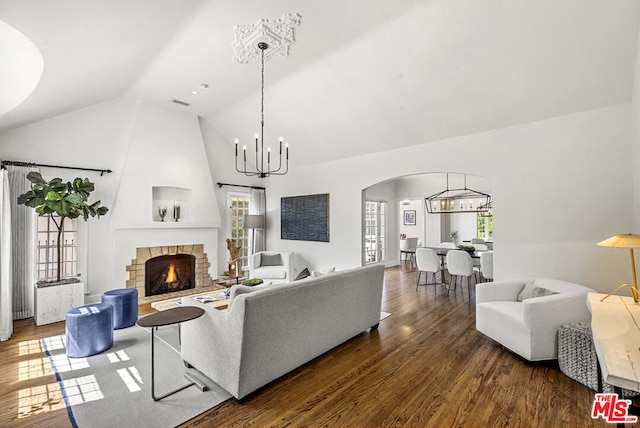 living room featuring a fireplace, plenty of natural light, high vaulted ceiling, and dark hardwood / wood-style floors