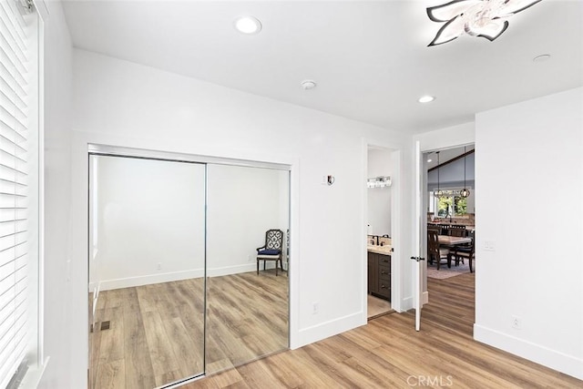 unfurnished bedroom with hardwood / wood-style floors and a closet