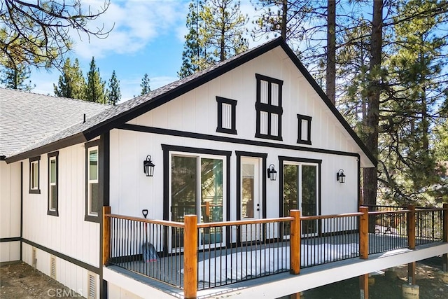 rear view of house featuring a wooden deck