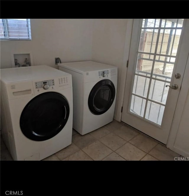 150136 Del Rey Dr, Big River, CA 92242 - washroom featuring a healthy amount of sunlight, light tile patterned floors, and washing machine and clothes dryer
