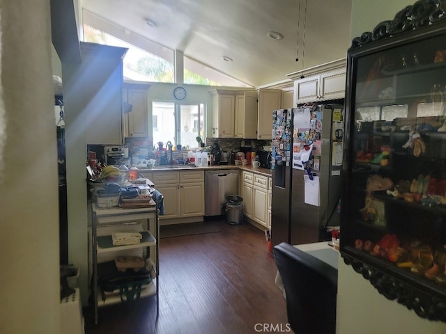 kitchen featuring stainless steel appliances, decorative backsplash, dark hardwood / wood-style flooring, lofted ceiling, and sink