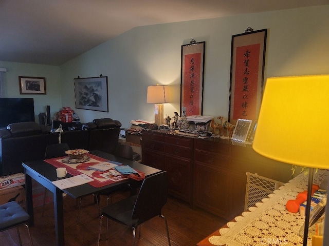 dining room with lofted ceiling and wood-type flooring