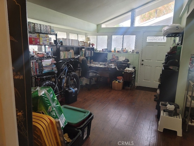 misc room with dark hardwood / wood-style flooring and vaulted ceiling