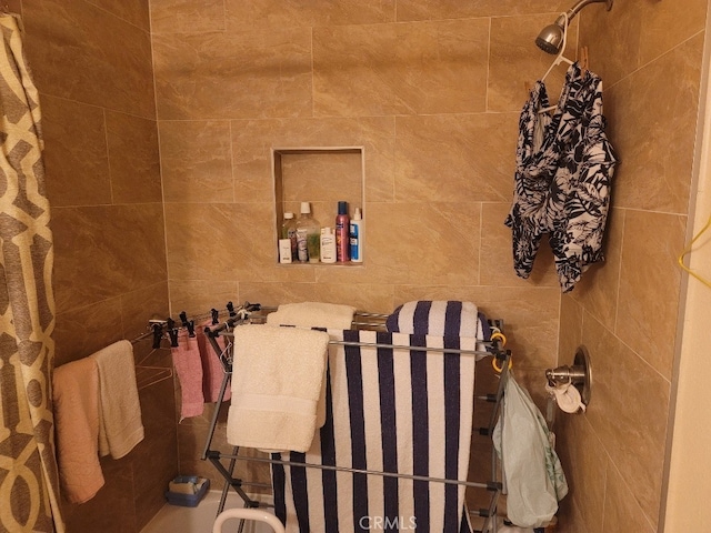 bathroom with a tile shower