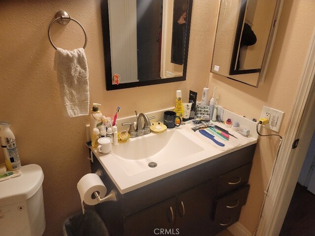 bathroom featuring toilet and vanity