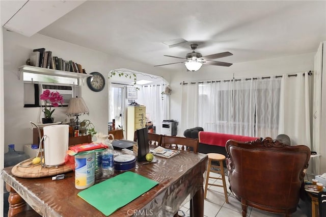 tiled dining room featuring ceiling fan and plenty of natural light