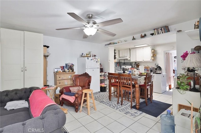 dining area with ceiling fan, light tile patterned floors, and washer / dryer