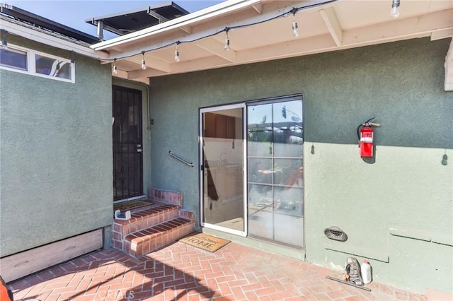 property entrance with a patio