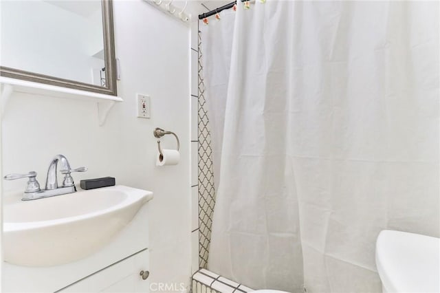 bathroom with vanity, toilet, and walk in shower