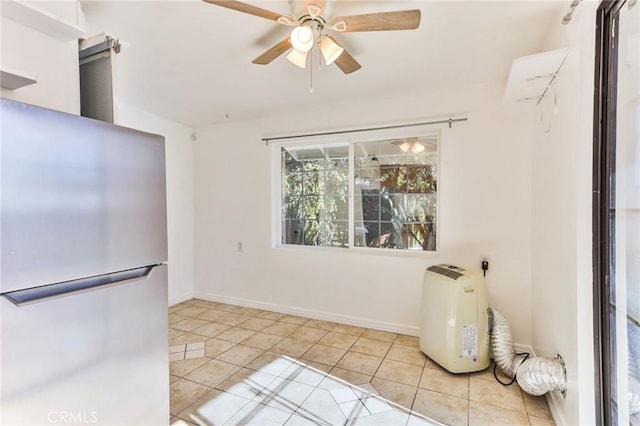 interior space featuring ceiling fan, stainless steel fridge, and light tile patterned flooring