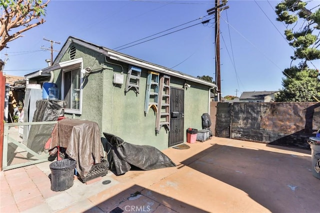 view of side of home featuring a patio area