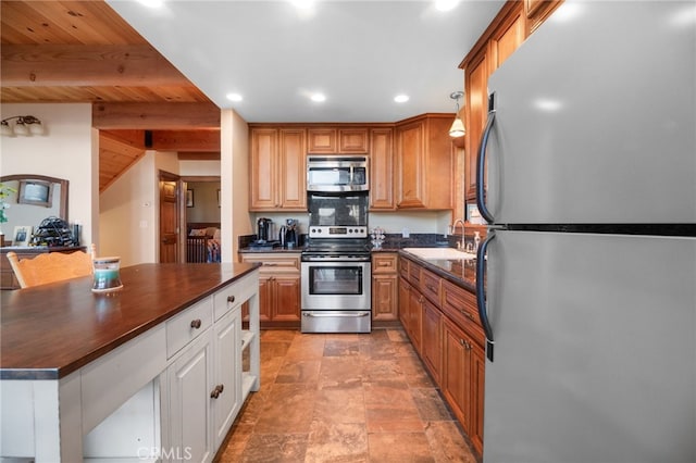 kitchen with beamed ceiling, wooden ceiling, sink, and appliances with stainless steel finishes