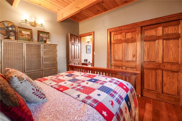 bedroom featuring dark wood-type flooring, beamed ceiling, and wooden ceiling