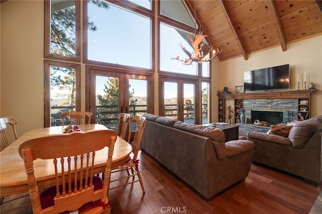 living room with high vaulted ceiling and a wealth of natural light