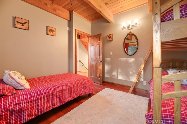 bedroom with beamed ceiling, hardwood / wood-style floors, and wooden ceiling