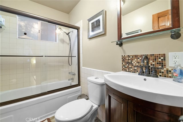 full bathroom featuring shower / bath combination with glass door, backsplash, vanity, and toilet