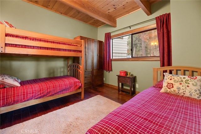 bedroom featuring wood ceiling, beamed ceiling, and dark wood-type flooring