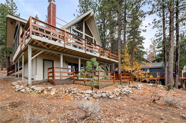 rear view of house with a wooden deck