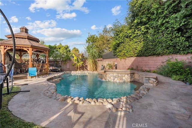 view of pool featuring a gazebo, an in ground hot tub, and a patio