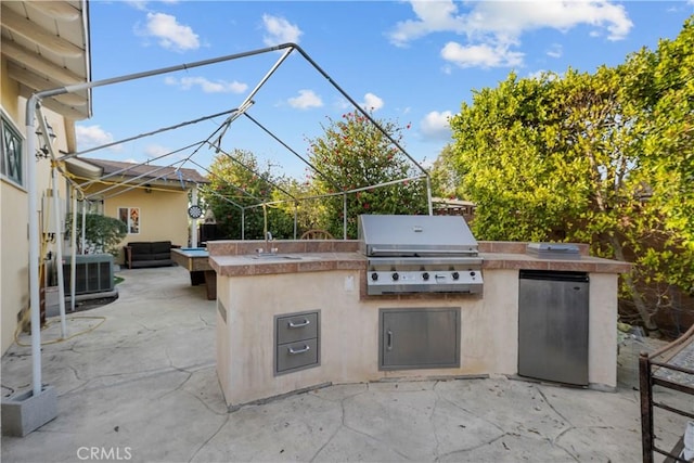 view of patio / terrace featuring central air condition unit, grilling area, and exterior kitchen