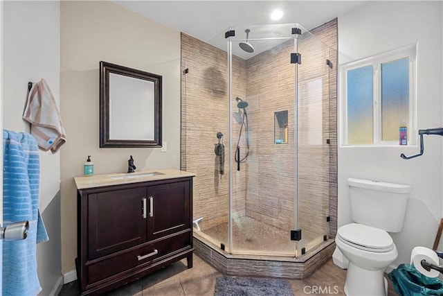 bathroom with walk in shower, tile patterned flooring, vanity, and toilet