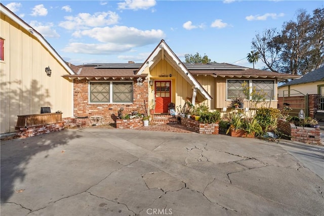 view of front of home featuring solar panels