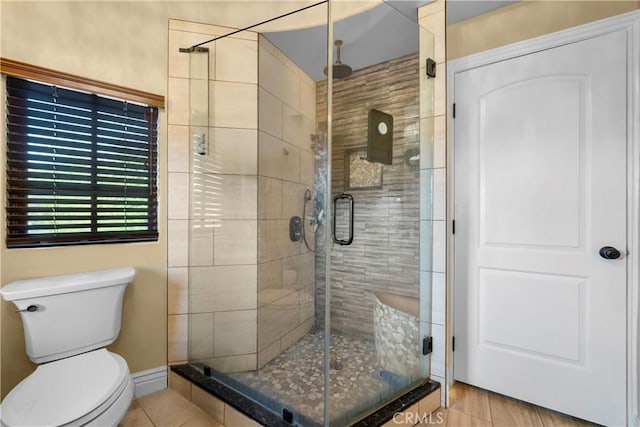 bathroom featuring toilet and walk in shower