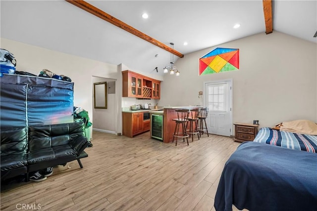 bedroom featuring light wood-type flooring, lofted ceiling with beams, bar, and beverage cooler