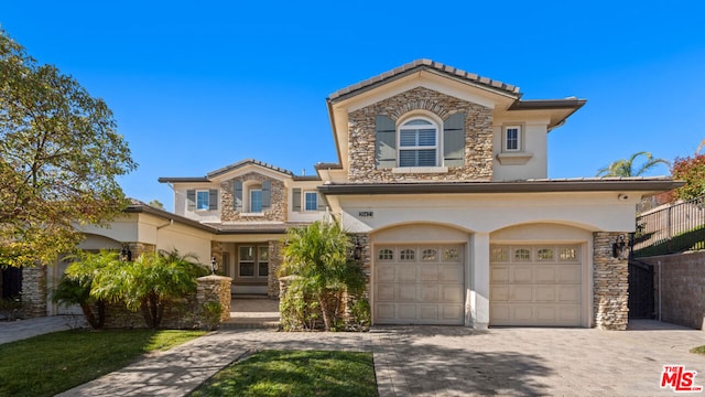 mediterranean / spanish home featuring a garage