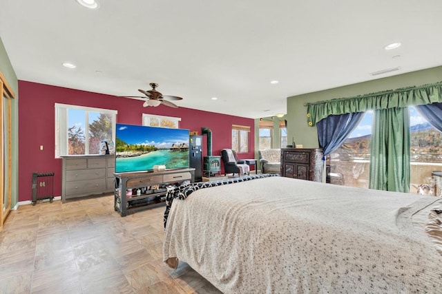 bedroom featuring multiple windows and ceiling fan